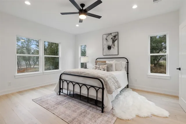 a bedroom with a large bed and a window