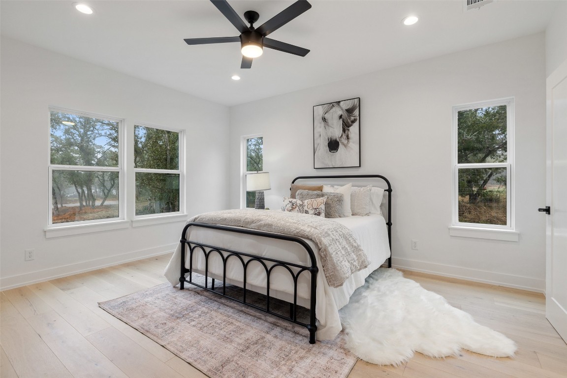 408 Rust Ranch Road Blanco, TX 78606 - Photo 20 of 35 a bedroom with a large bed and a window