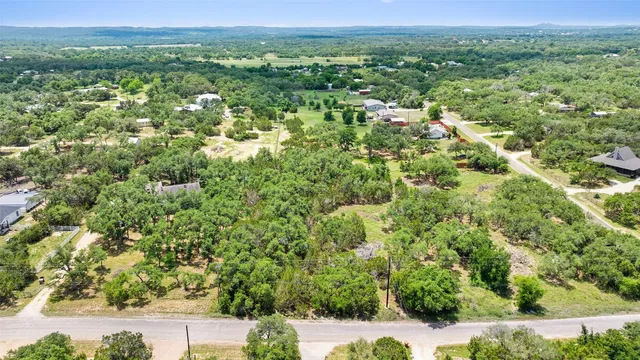 a view of a green field with lots of bushes