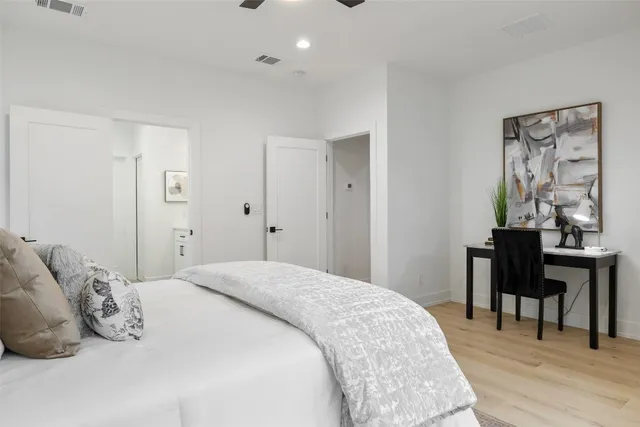 a bedroom with a bed and a table in it