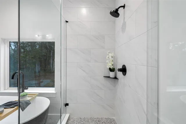 a bathroom with a tub and shower