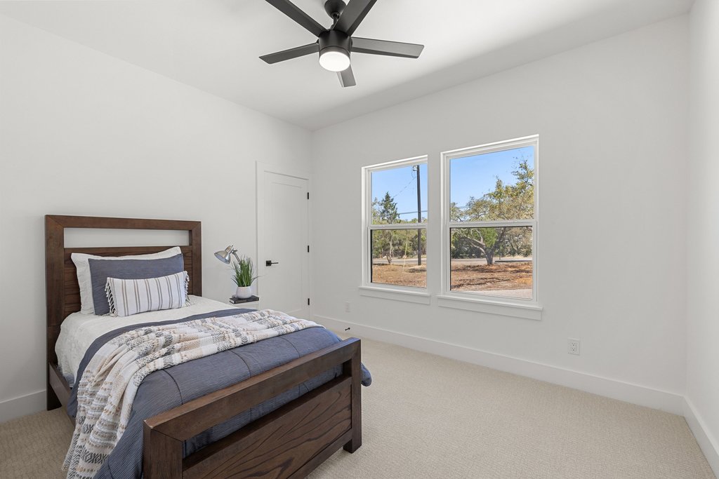 408 Rust Ranch Road Blanco, TX 78606 - Photo 22 of 34 Bedroom featuring light colored carpet and ceiling fan