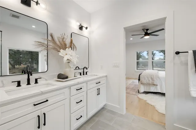 a en suite bathroom with double sink and a mirror