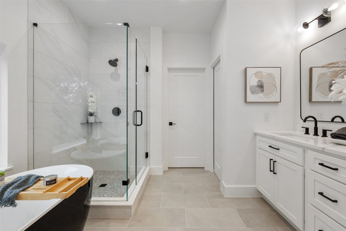 408 Rust Ranch Road Blanco, TX 78606 - Photo 27 of 35 a bathroom with a tub sink vanity and mirror