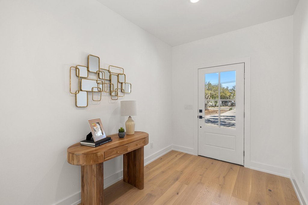 408 Rust Ranch Road Blanco, TX 78606 - Photo 3 of 34 Doorway to outside with baseboards and wood finished floors