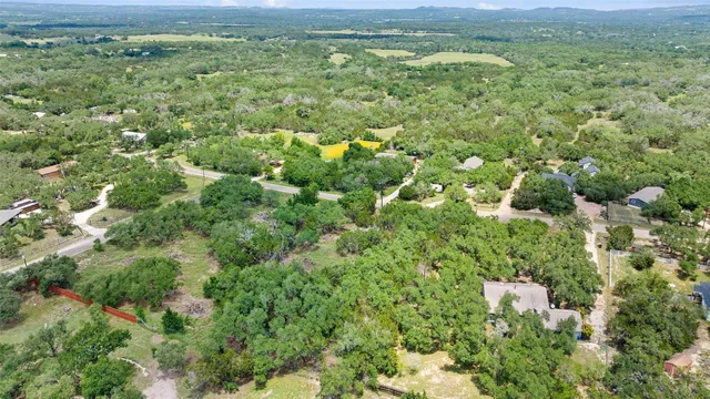 a view of a city with lush green forest