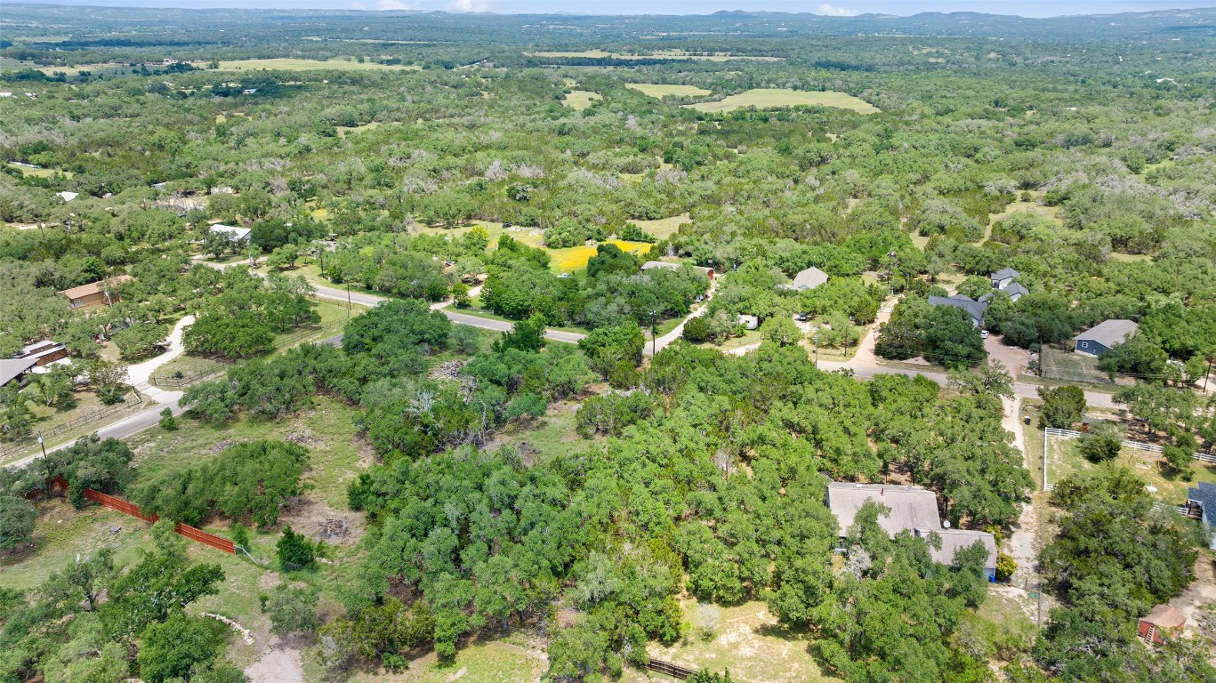 408 Rust Ranch Road Blanco, TX 78606 - Photo 3 of 35 a view of a city with lush green forest