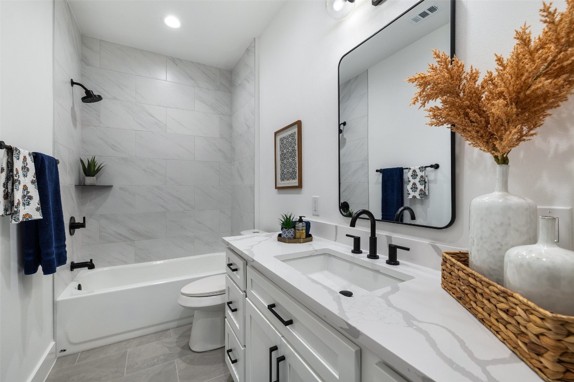 408 Rust Ranch Road Blanco, TX 78606 - Photo 31 of 35 a bathroom with a toilet sink and bathtub