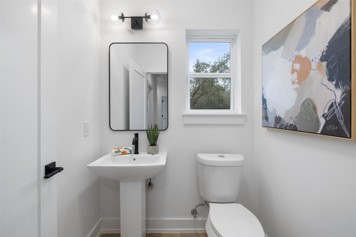 408 Rust Ranch Road Blanco, TX 78606 - Photo 33 of 35 a bathroom with a toilet sink and mirror