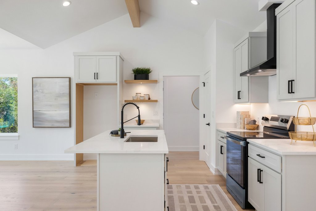 408 Rust Ranch Road Blanco, TX 78606 - Photo 10 of 34 Kitchen featuring stainless steel range with electric stovetop, an island with sink, light stone counters, open shelves, and recessed lighting