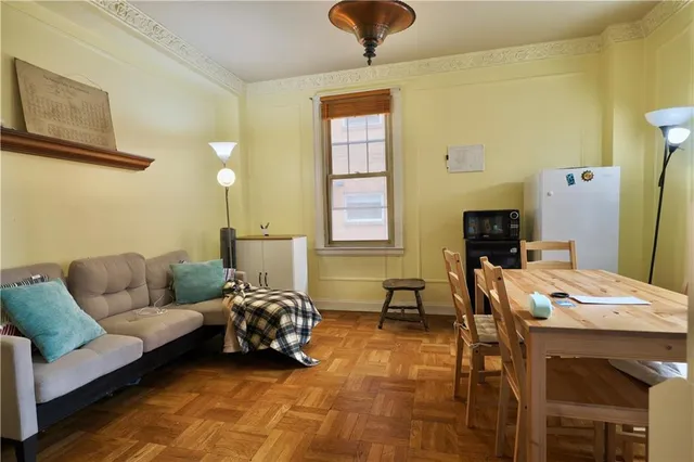 a dining room with furniture and a floor to ceiling window