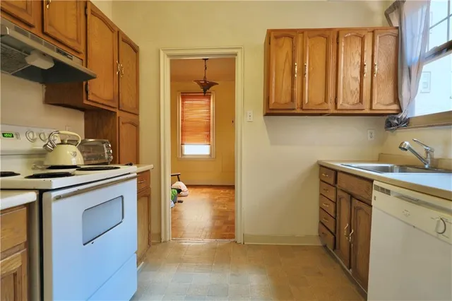 a view of kitchen with a sink cabinets and a window