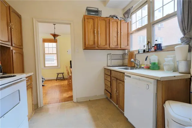 a view of a storage & utility room with a stove fridge