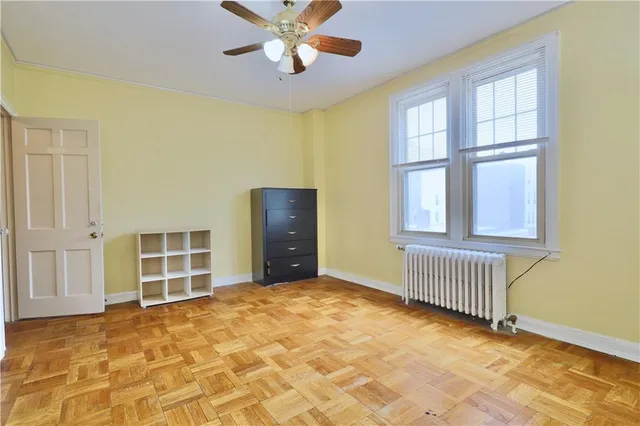 a view of a room with wooden floor and a bathroom