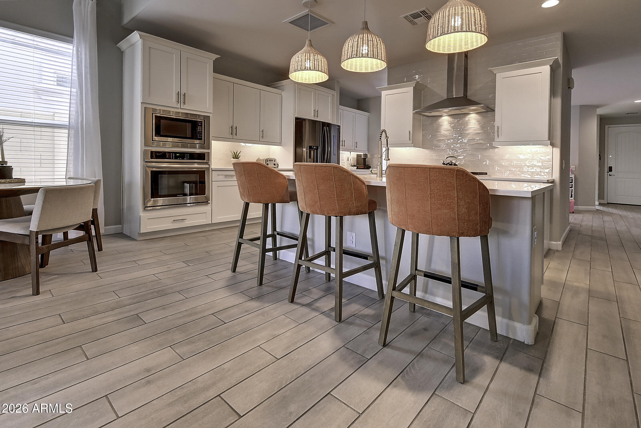 2140 East Alameda Road Phoenix, AZ 85024 - Photo 12 of 54 a view of a dining room with furniture window and wooden floor