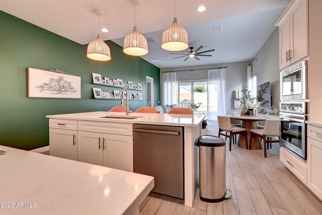 a kitchen with a sink cabinets and wooden floor