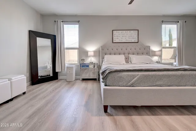 a spacious bathroom with a granite countertop sink a toilet and a mirror