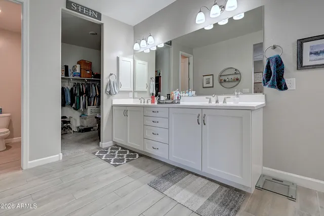a bathroom with a double vanity sink mirror and shower