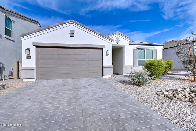 a view of a house with a yard and large tree