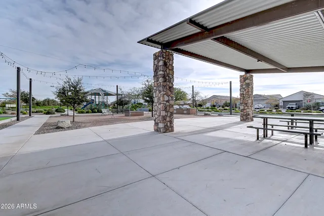 a view of a patio with a table and chairs under an umbrella