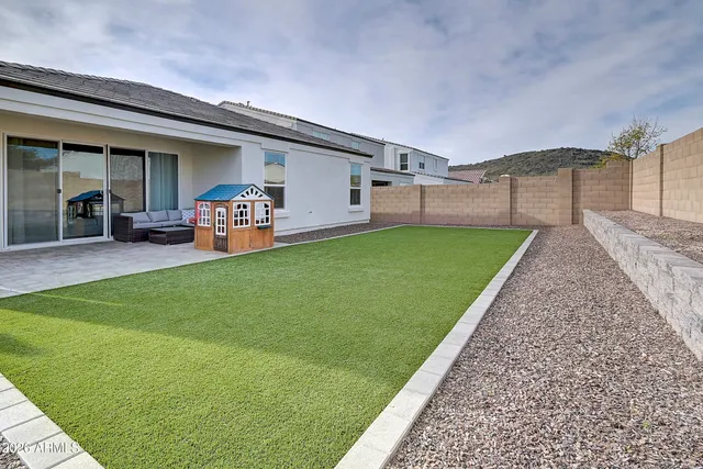 a view of a house with backyard porch and sitting area