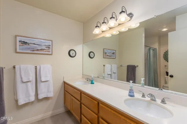 a bathroom with a double vanity sink and a mirror