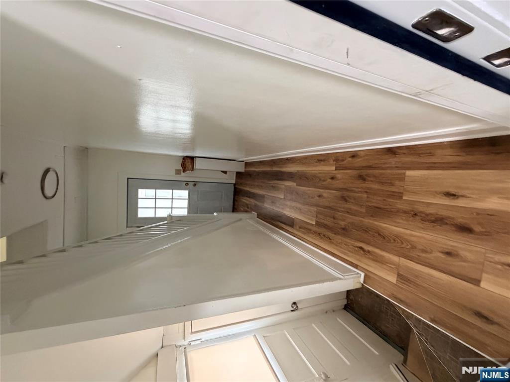 46 High Street Clifton, NJ 07014 - Photo 13 of 14 a view of a hallway with wooden floor and staircase