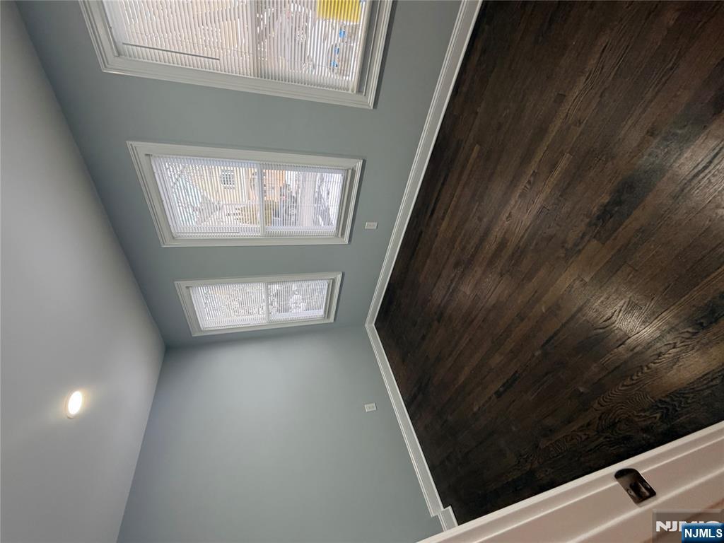 46 High Street Clifton, NJ 07014 - Photo 6 of 14 an empty room with wooden floor and windows