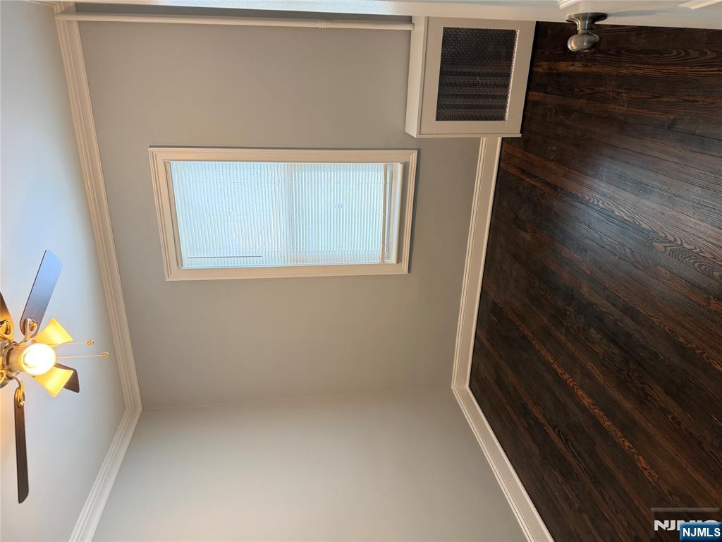 46 High Street Clifton, NJ 07014 - Photo 7 of 14 a view of an empty room with wooden floor and a window