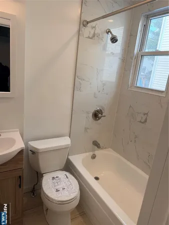 a white toilet sitting next to a bath tub shower