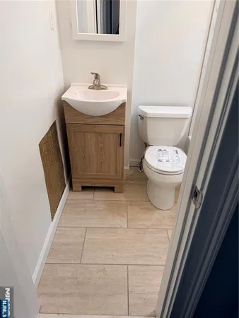 a bathroom with a sink a toilet and a mirror
