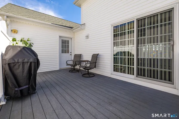 a view of a deck with chair and wooden floor