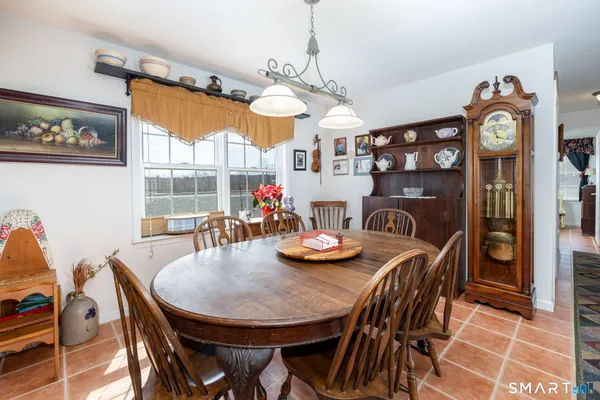 a view of a dining room with furniture and chandelier