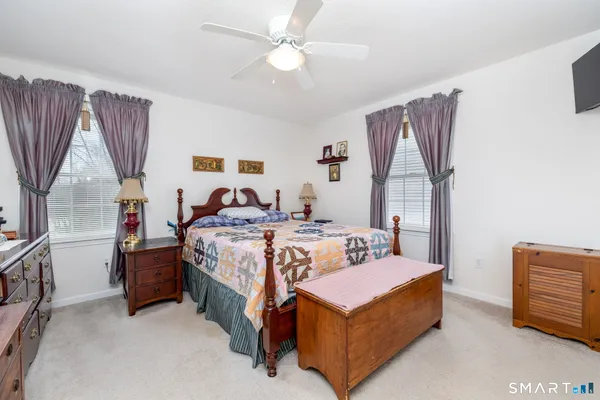 a bedroom with a bed couch and a window