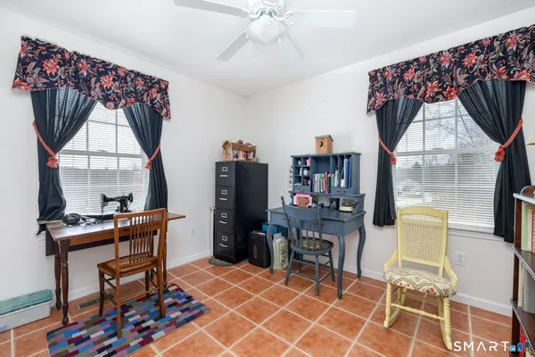 a work room with furniture and a window