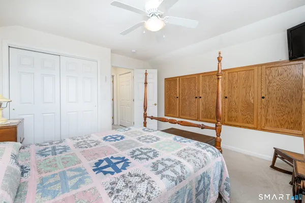 a bedroom with a bed and a chandelier