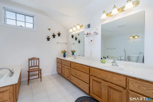 a spacious bathroom with a sink double vanity and a mirror