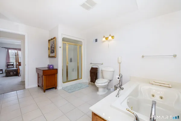 a bathroom with a sink a toilet and bathtub