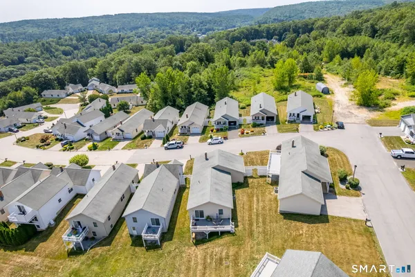 an aerial view of residential houses with outdoor space