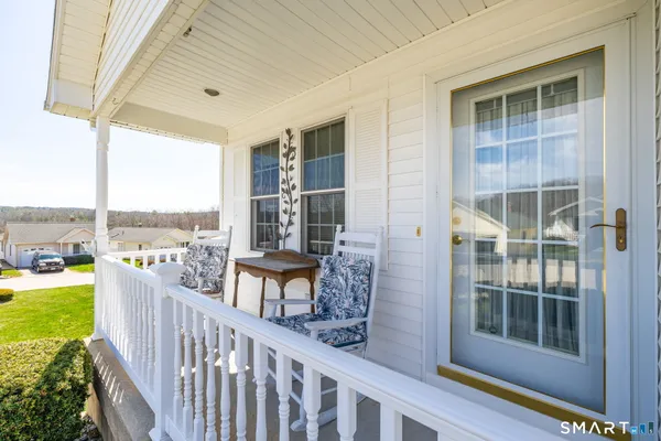 a view of a balcony with lake view and wooden floor
