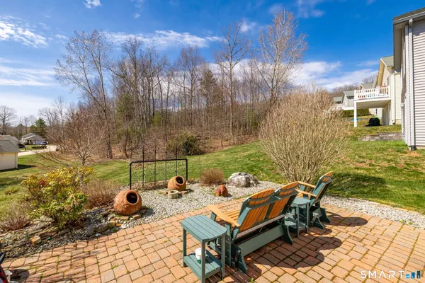 a view of a patio with a table and chairs