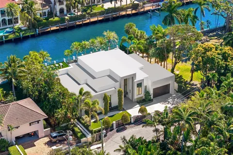 an aerial view of a house with a garden and lake view