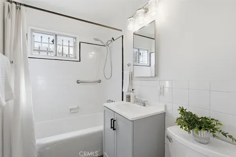 a bathroom with a sink mirror and a bathtub