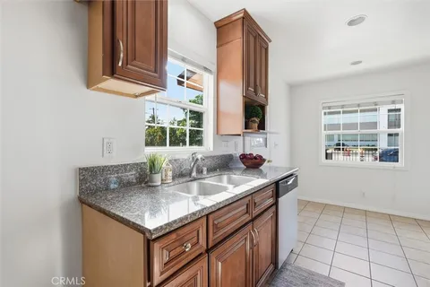 a kitchen with stainless steel appliances granite countertop a sink and a window