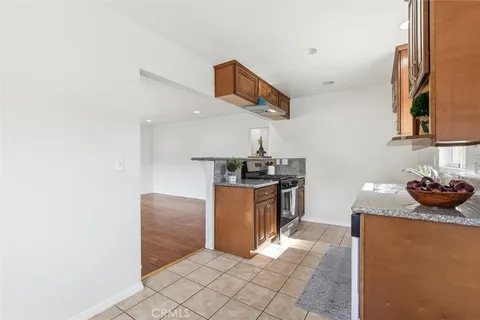 a kitchen with stainless steel appliances granite countertop a refrigerator and a stove