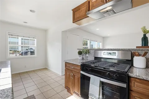 a stove top oven sitting inside of a kitchen