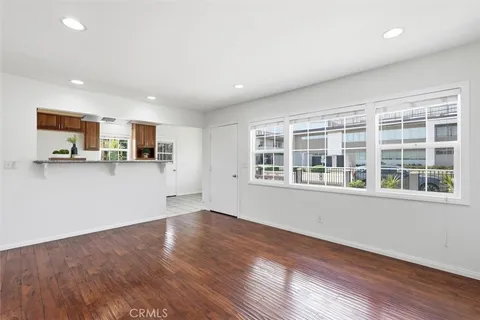 a view of a kitchen with wooden floor and electronic appliances