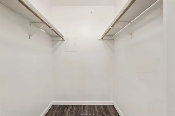 a view of walk in closet with empty racks
