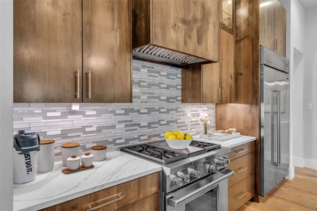 a kitchen with a sink stove and cabinets