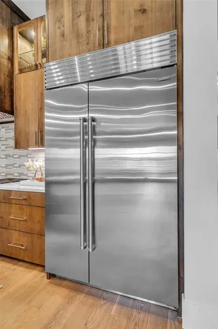a kitchen with a sink a counter top space and living room view